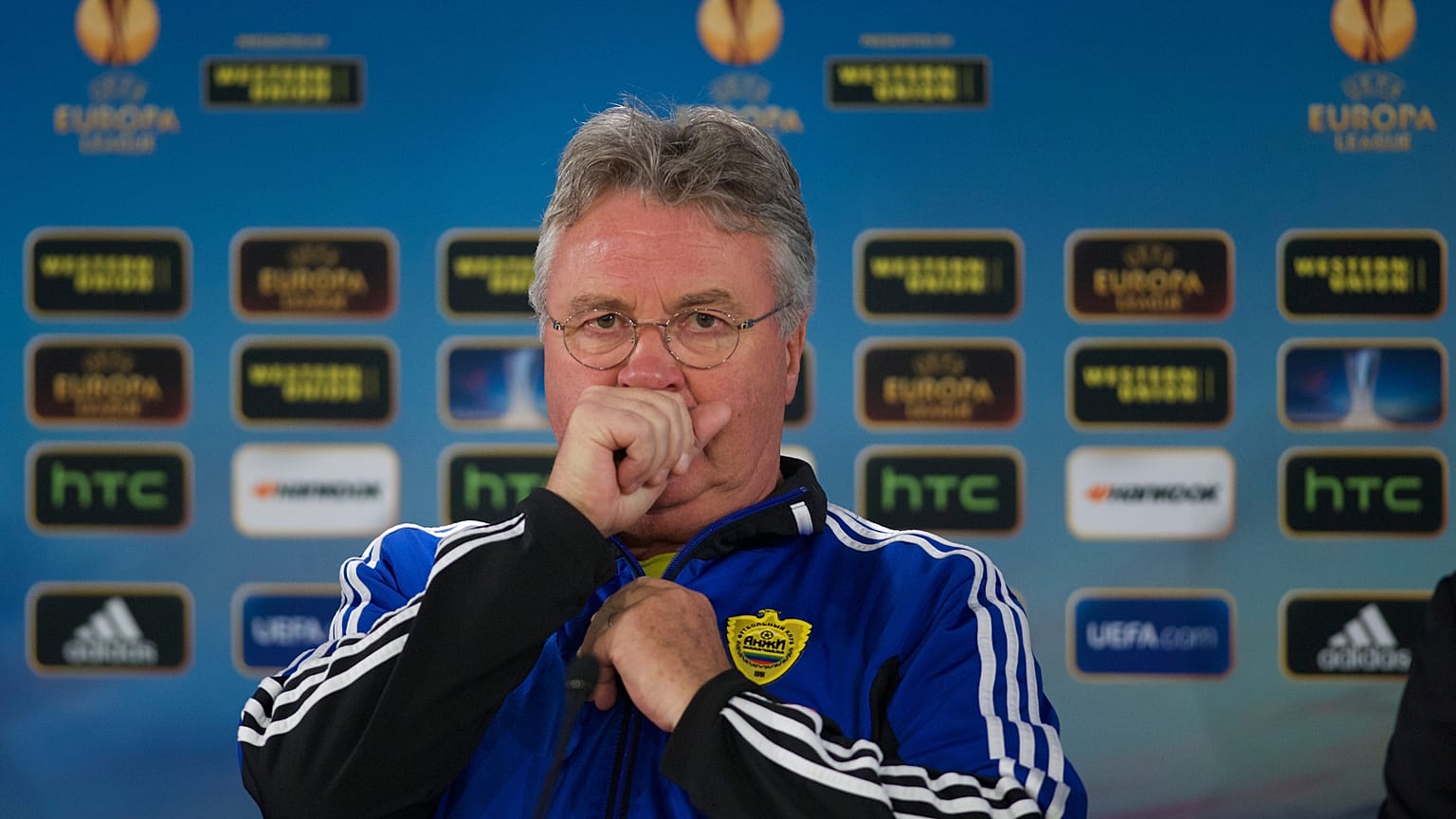 Anzhi's head coach Guus Hiddink of Netherlands coughs during a news conference
