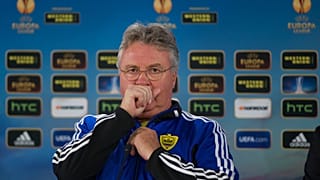 Anzhi's head coach Guus Hiddink of Netherlands coughs during a news conference