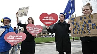 Anti-Brexit demonstrators carry placards and the European Union flag