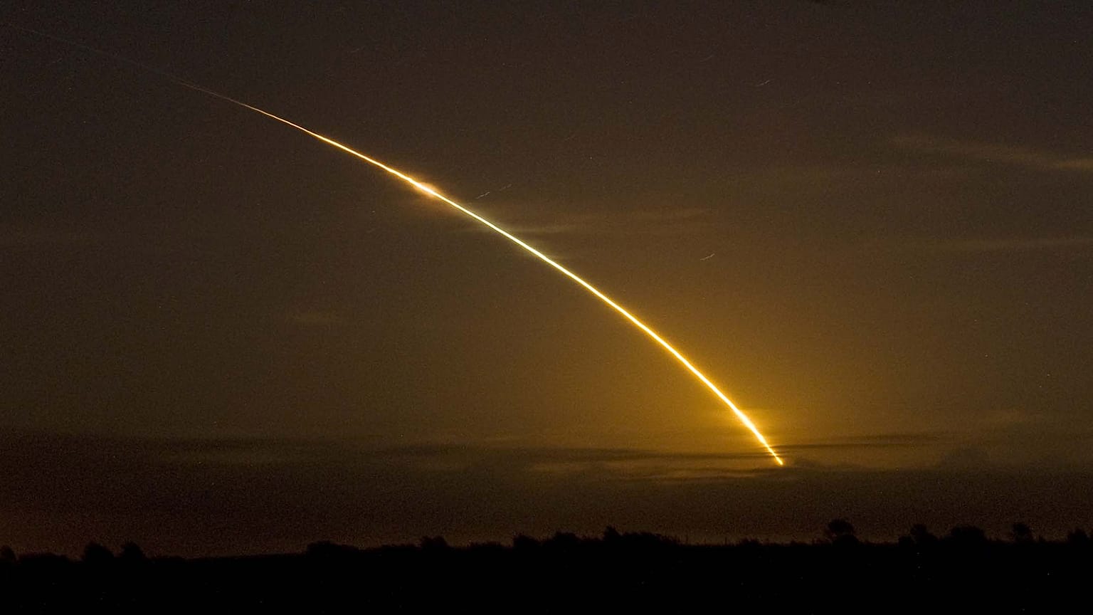 The Space shuttle Discovery streaks across the sky as it clears a cloud bank as seen from Archer, Fla. Saturday, Aug., 29, 2009. Discovery's seven member crew are on a mission