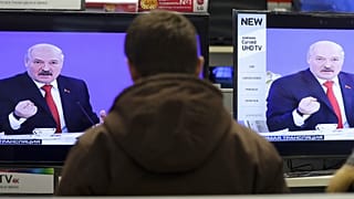 Belarus's President Alexander Lukashenko is seen on TV screens inside a shop