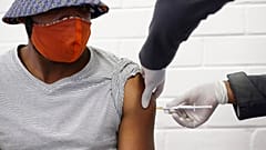 a volunteer receives a COVID-19 test vaccine injection developed at the University of Oxford in Britain, June 24, 2020