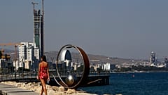 A woman walks across the sea in southern coastal city of Limassol, Cyprus