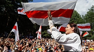 Sviatlana Tsikhanouskaya, candidate for the presidential elections, greets people waving old Belarus flags during a rally in Brest, Belarus.