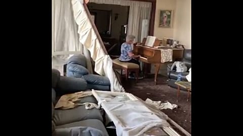 Elderly lady plays piano in damaged Beirut apartment