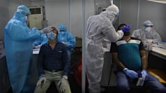 Indian health volunteers take swab samples for at a COVID-19 test study camp at a government hospital in New Delhi.