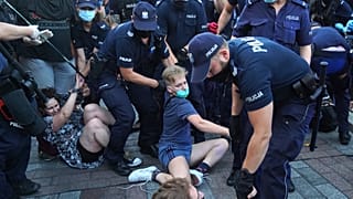 Dozens were arrested as they tried to stop the detention of an LGBT activist.