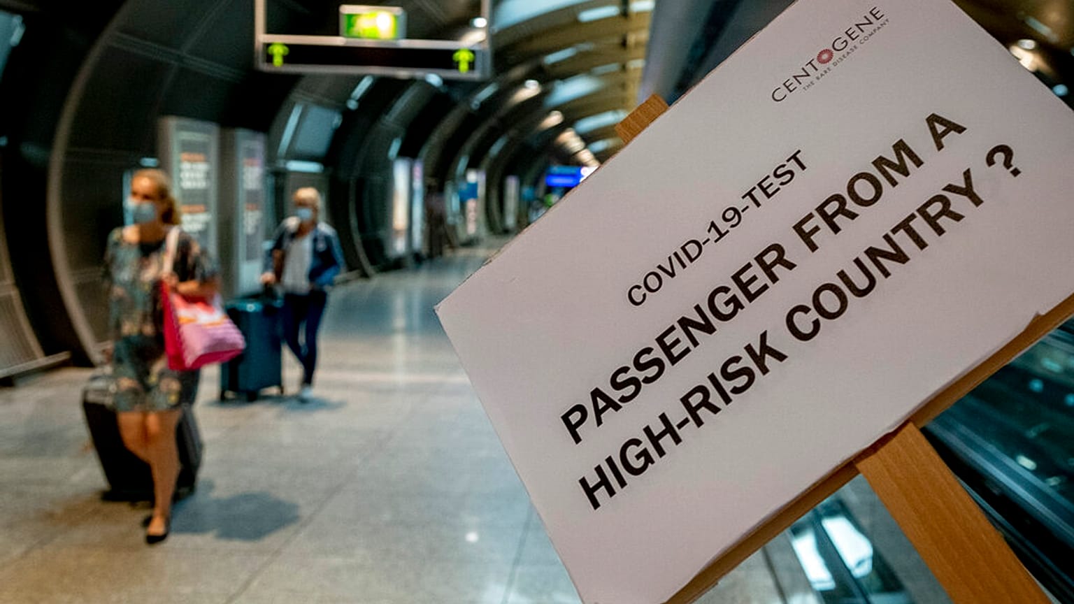 A sign helps passengers to find the COVID-19 test center at the airport in Frankfurt, Germany, Saturday, Aug. 8, 2020