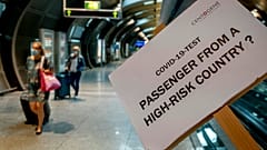 A sign helps passengers to find the COVID-19 test center at the airport in Frankfurt, Germany, Saturday, Aug. 8, 2020