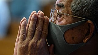 A man attends mass held in memory of bomb victims at Urakami Church to mark the 75th anniversary of the atomic bombing of Nagasaki, in the city on August 9, 2020.
