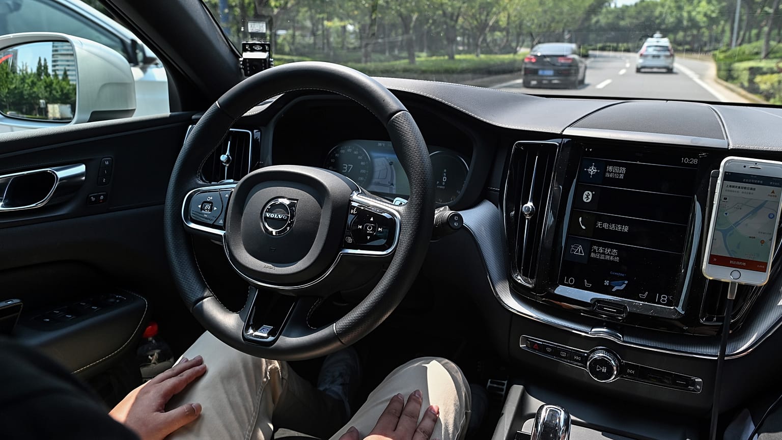 A driver sitting in a Didi Chuxing autonomous taxi on the streets in Shanghai.