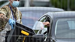 FILE - In this file photo dated Tuesday June 30, 2020, a coronavirus test sample is collected at a coronavirus testing station in Leicester, England. 