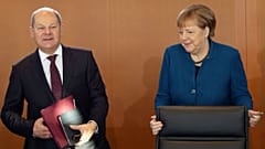 German Chancellor Angela Merkel arrives besides Vice Chancellor and Finance Minister Olaf Scholz 