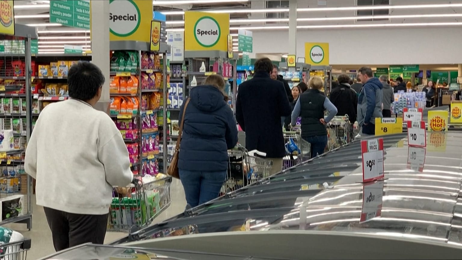 People queuing inside supermarket, waiting to checkout