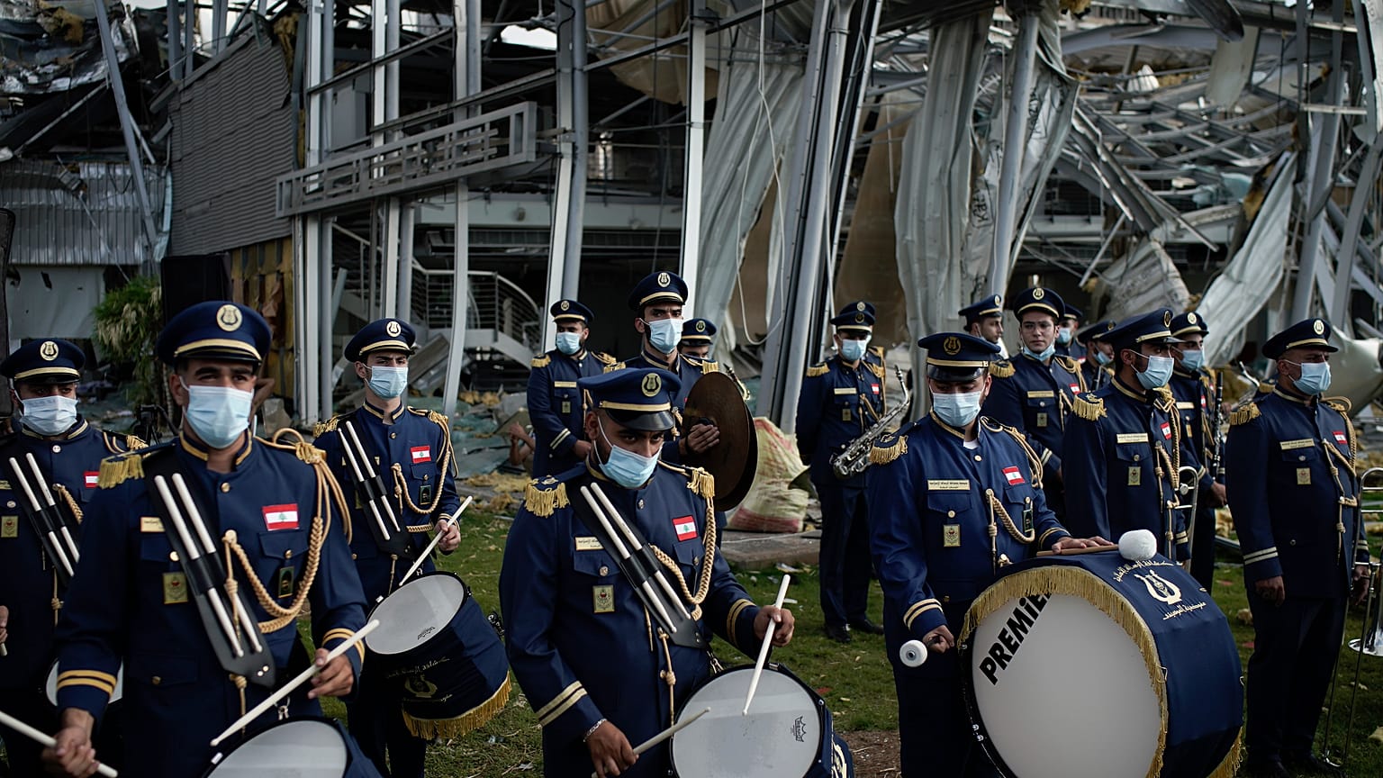 A scouts band performs in honor of the victims of the last week's explosion, the city, near the blast site in Beirut, Lebanon, Tuesday, Aug. 11, 2020.