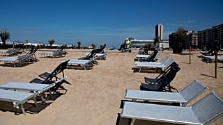 Belgium's interior minister has stepped into defend free movement after several towns imposed beach bans on day trippers