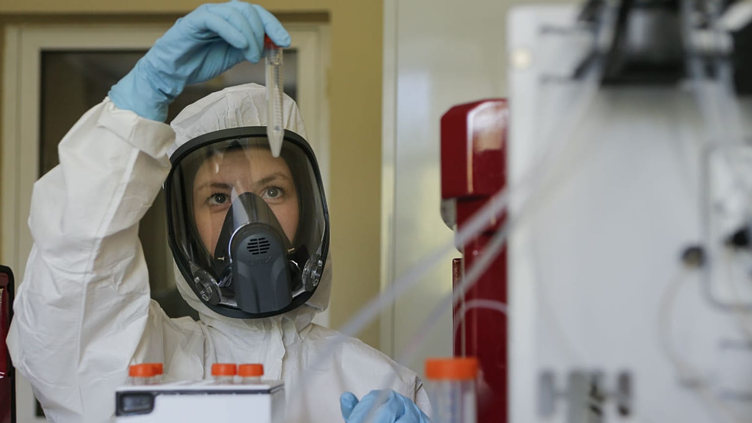 Thursday, Aug. 6, 2020, and provided by Russian Direct Investment Fund, an employee shows a new vaccine at the Nikolai Gamaleya  