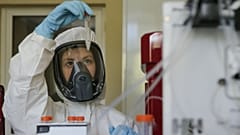 Thursday, Aug. 6, 2020, and provided by Russian Direct Investment Fund, an employee shows a new vaccine at the Nikolai Gamaleya  