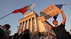 Protesters carry a poster reading "Borissov, I am not afraid, but you are! Resignation" (in Bulgarian) during a mass protest in downtown Sofia, Bulgaria, on July 29.