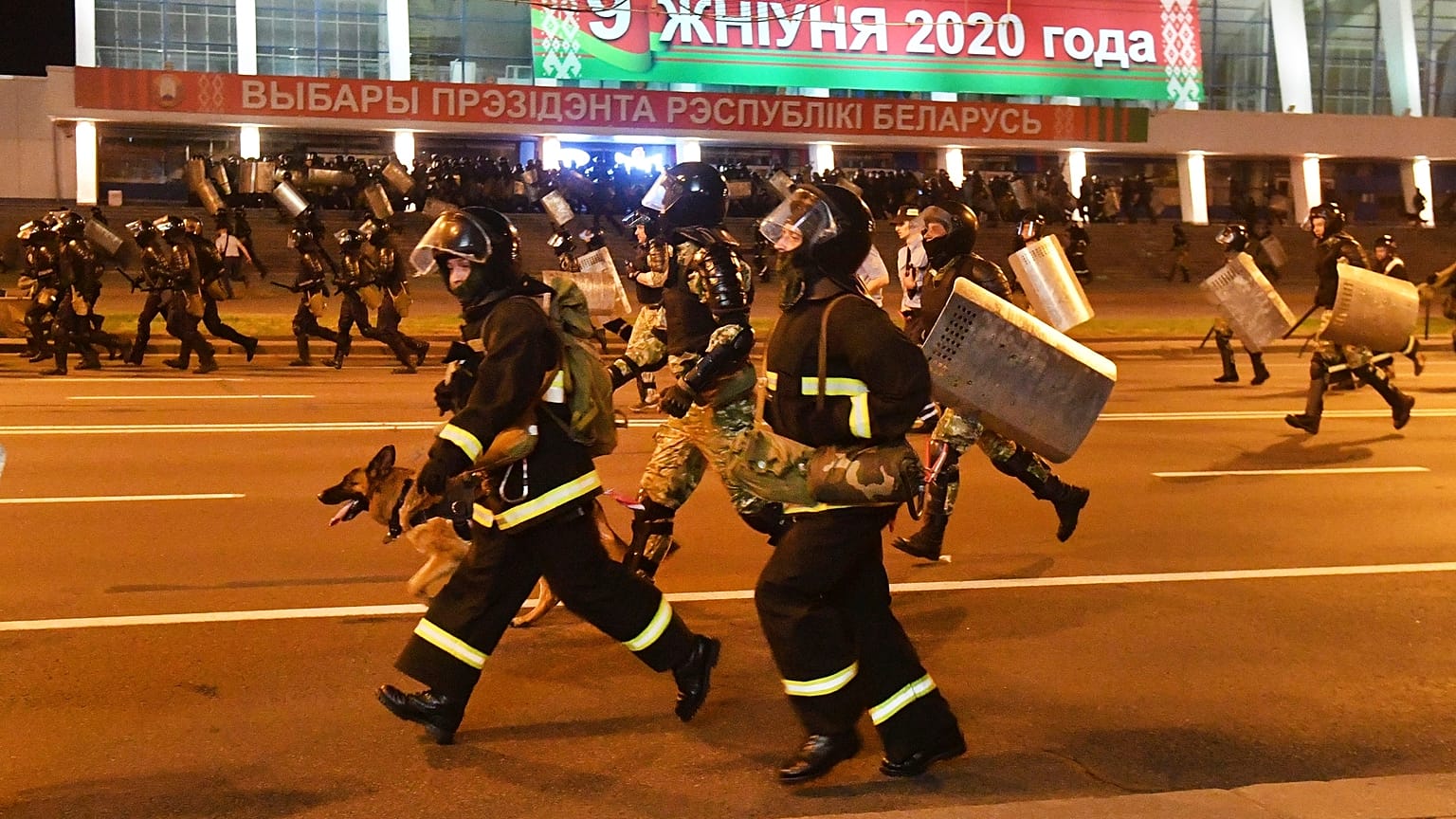 Police run to block demonstrators during a rally after the Belarusian presidential election in Minsk, Belarus, late Sunday, Aug. 9, 2020. 