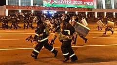 Police run to block demonstrators during a rally after the Belarusian presidential election in Minsk, Belarus, late Sunday, Aug. 9, 2020. 
