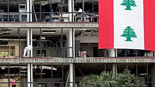 A picture of victims is displayed inside their damaged apartment facing the port of Beirut.