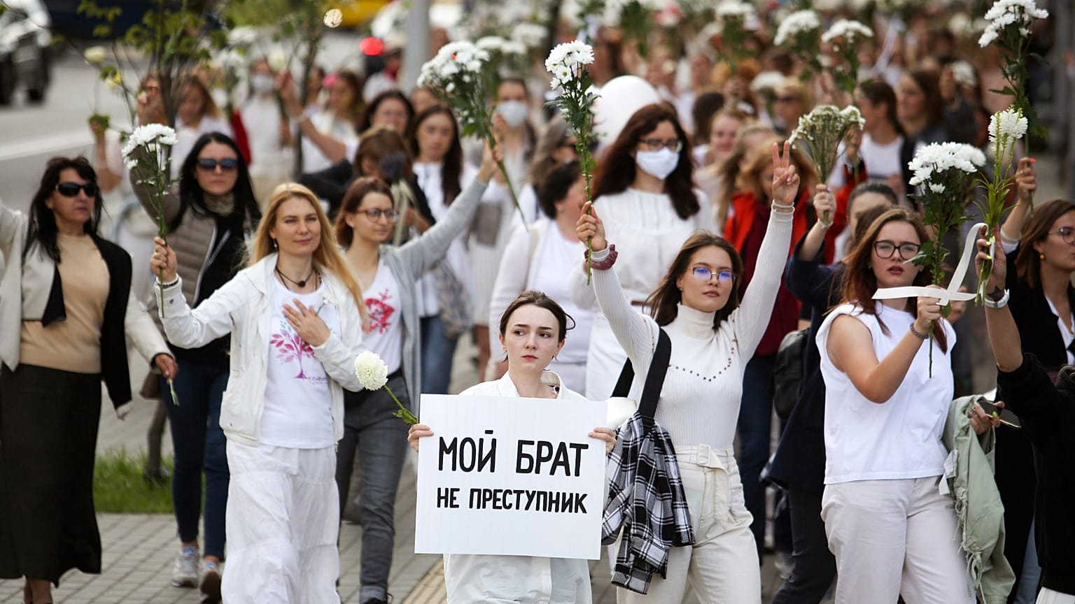 Belarusian women, one with a poster reading "My brother is not a criminal", rally in solidarity with protesters caught up in the state post-election crackdown, Minsk, Aug. 13.