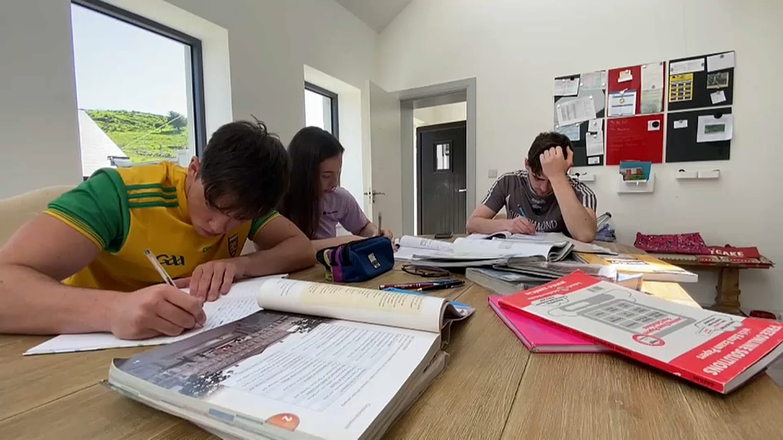 A group of students takes notes