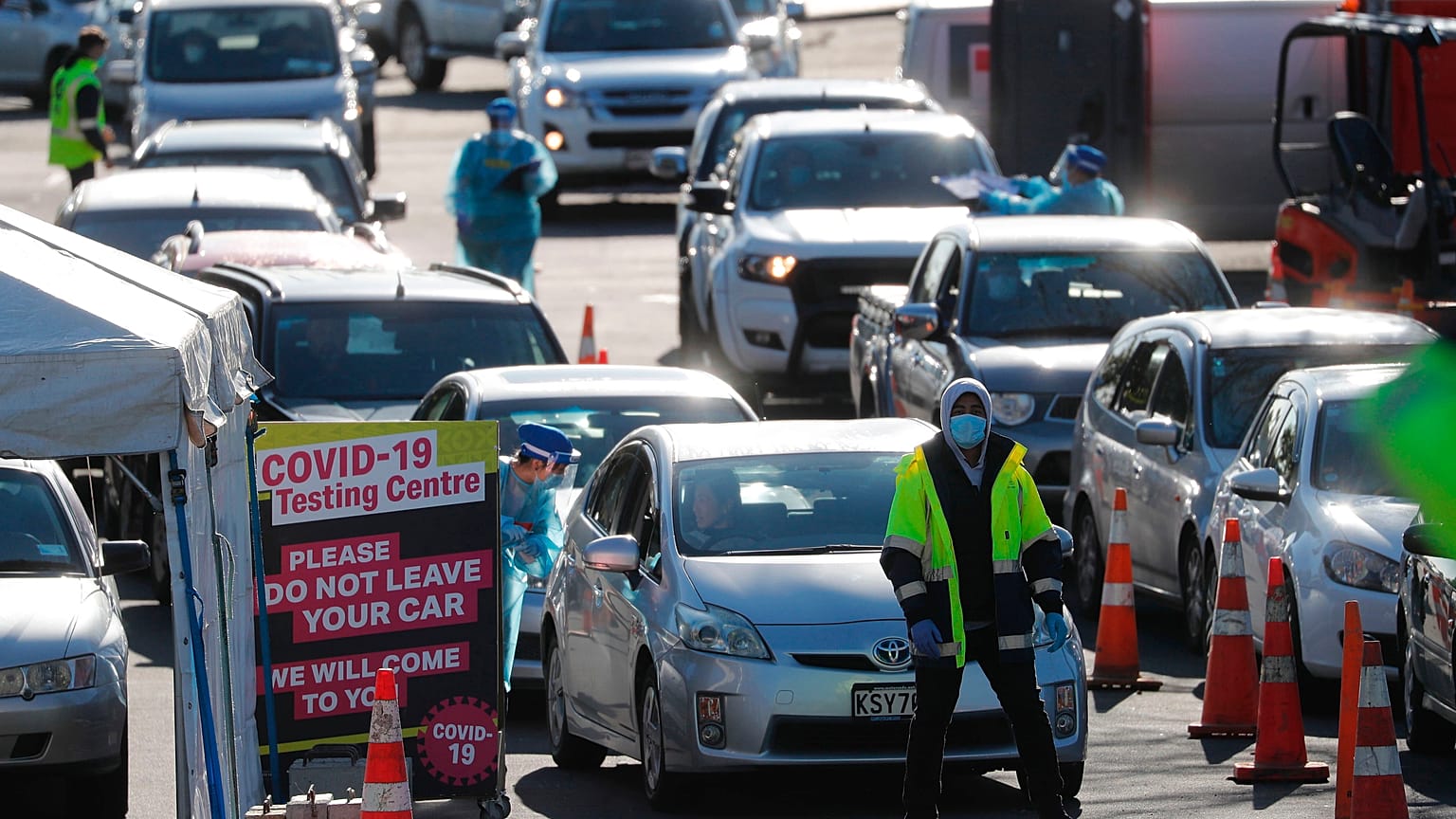 Cars queue at a COVID-19 test centre in Auckland, New Zealand