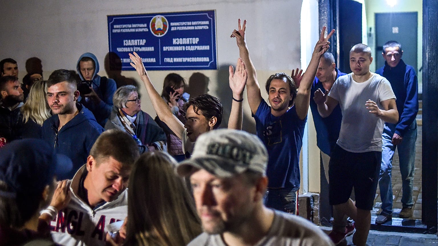 People detained during recent rallies of opposition supporters leave the Okrestina prison early morning in Minsk on August 14, 2020.