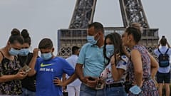 A Italian tourist family wearing a masks to prevent the spread of COVID-19 gather at Trocadero plaza near Eiffel Tower in Paris