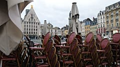 Chairs are stacked up outside an empty restaurant in the center of Lille, northern France