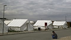 A migrant from Syria rests at a refugee camp in Kokkinotrimithia outside of Nicosia, Cyprus