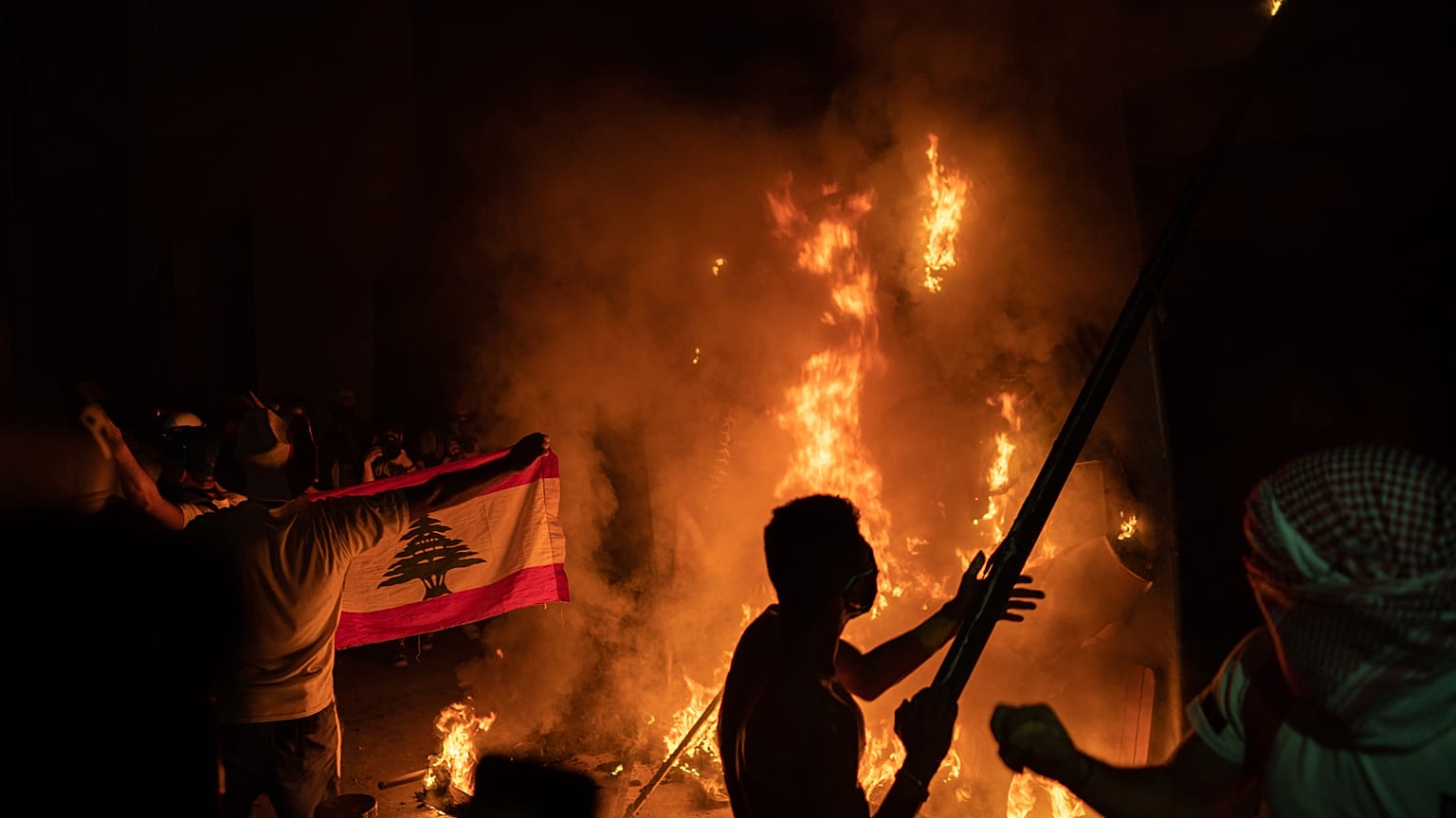 Anti-government protesters burn a barricade near the Parliament building, August 11