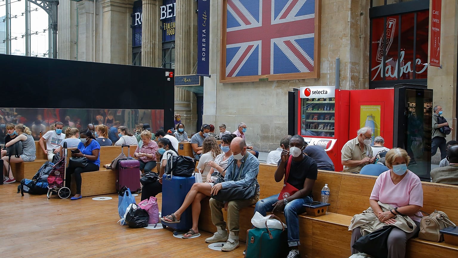 Passengers wait next to the Eurostar Terminal at the Gare du Nord train station in Paris