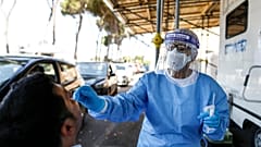 A man undergoes testing for COVID-19 at Rome's San Giovanni Addolorata hospital, Friday, Aug. 14, 2020.