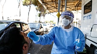 A man undergoes testing for COVID-19 at Rome's San Giovanni Addolorata hospital, Friday, Aug. 14, 2020.
