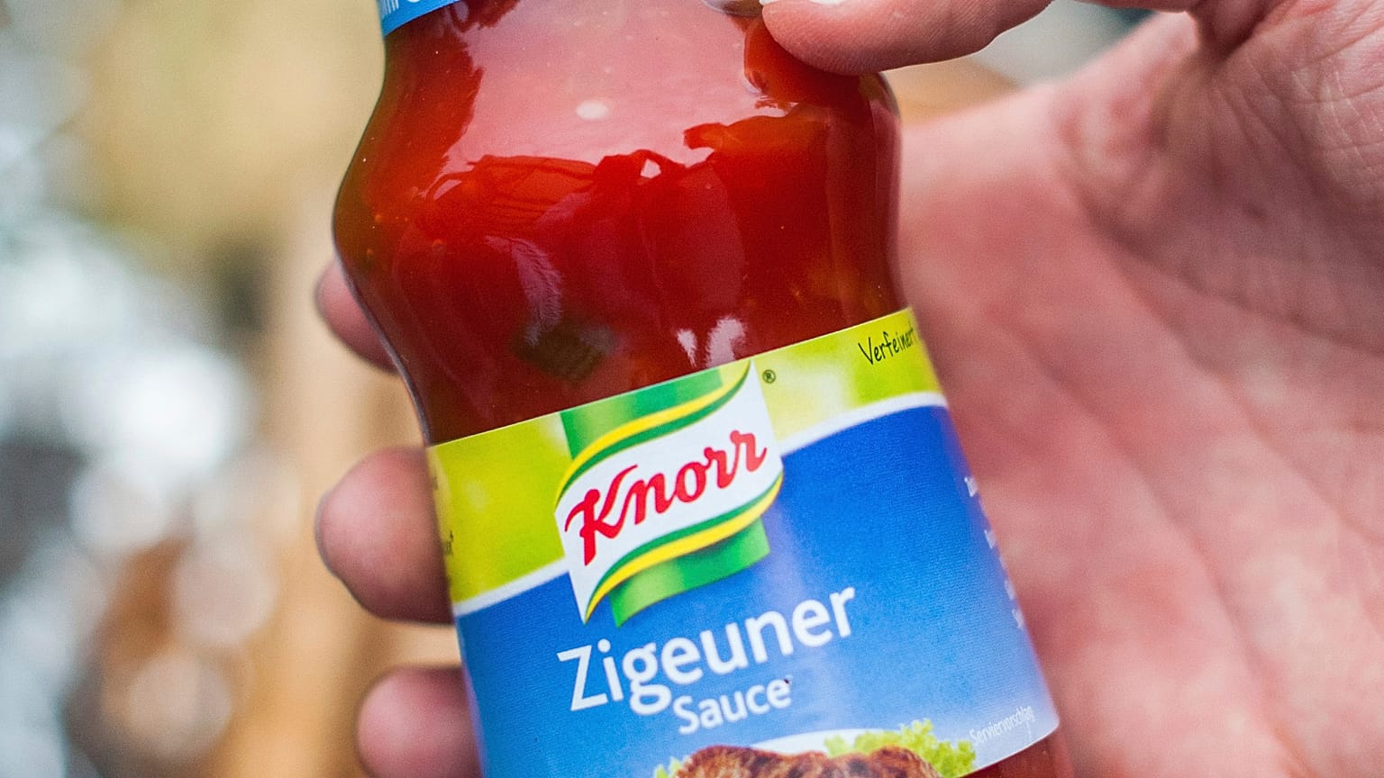 FILE- In this May 6, 2014 taken photo a man holds a bottle of "gypsy sauce" from the manufacturer Knorr in his hand in Berlin, Germany.