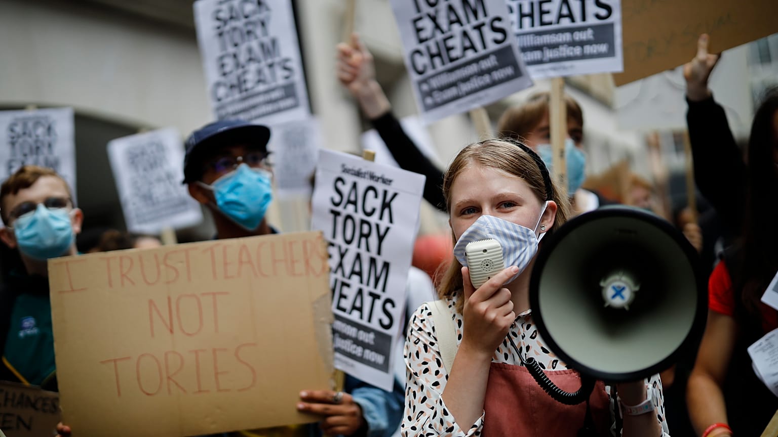 Students hold placards as they protest outside the Department for Education in central London on August 14, 2020.