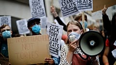 Students hold placards as they protest outside the Department for Education in central London on August 14, 2020.