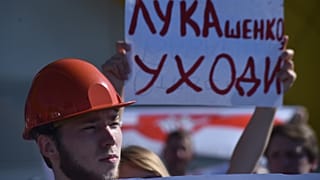 Workers of Minskenergo (Minsk Energy Company) hold a poster reading "Lukashenko go away!" during the rally in Minsk, on August 17, 2020,