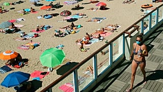 A woman wearing a face mask to protect against coronavirus, near the beach, in Saint Jean de Luz, southwestern France. 
