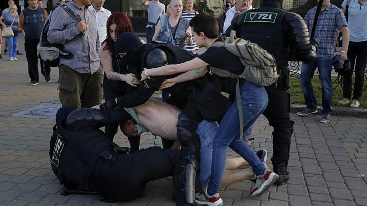 Le forze di sicurezza trattengono un manifestante