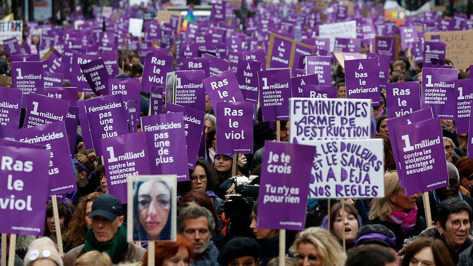 Women hold placards as they march against domestic violence, in Paris, Saturday, Nov, 23, 2019.