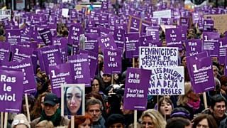 Women hold placards as they march against domestic violence, in Paris, Saturday, Nov, 23, 2019.