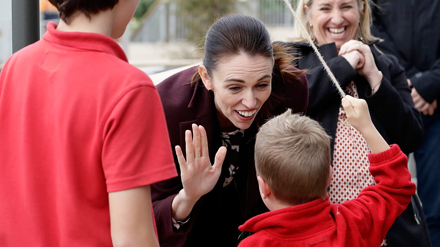 New Zealand Prime Minister Jacinda Ardern gestures with a student during the opening ceremony for Redcliffs School in Christchurch, New Zealand, Thursday, June 25, 2020