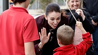 New Zealand Prime Minister Jacinda Ardern gestures with a student during the opening ceremony for Redcliffs School in Christchurch, New Zealand, Thursday, June 25, 2020