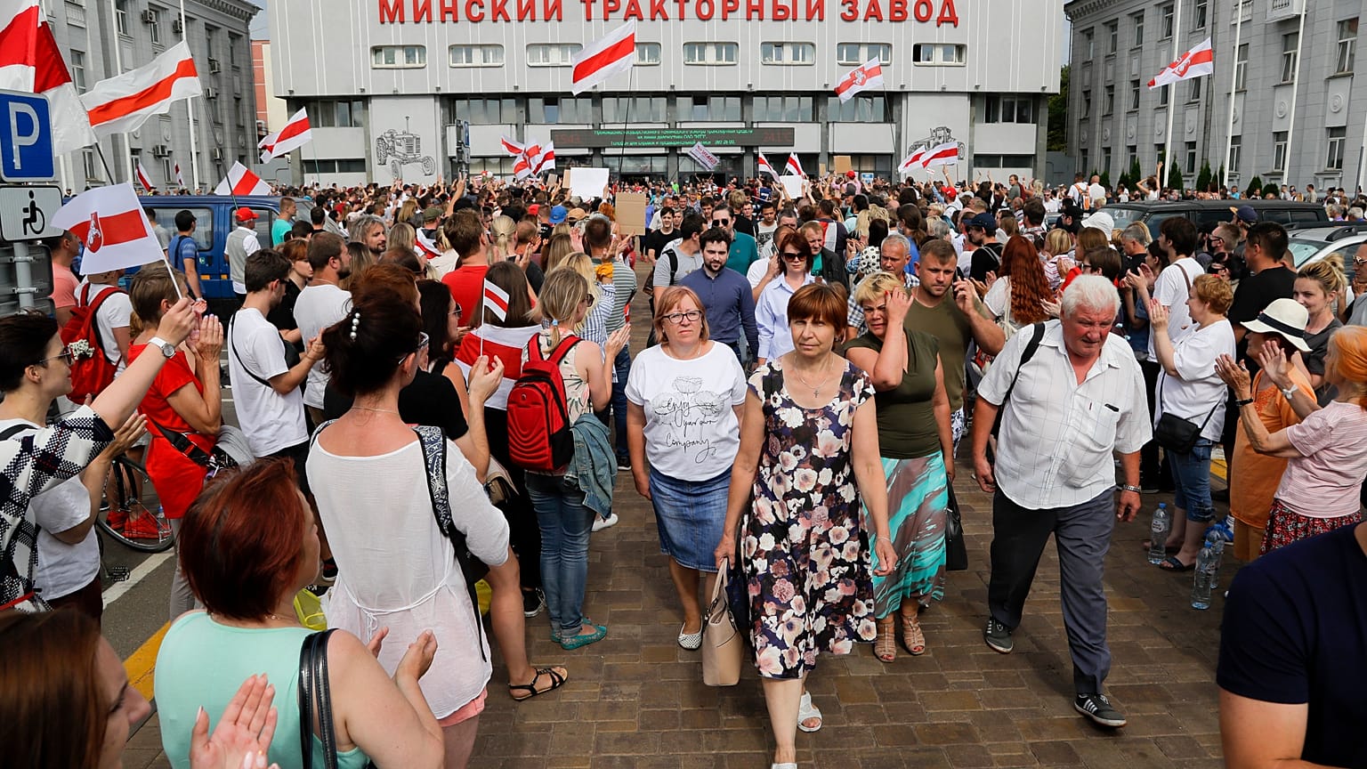 Workers leave the Minsk Tractor Works at the end of a shift on Tuesday, applauded by opposition workers