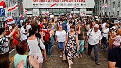 Workers leave the Minsk Tractor Works at the end of a shift on Tuesday, applauded by opposition workers