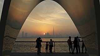  People enjoy a city skyline view with the World's tallest building Burj Khalifa, in Dubai, United Arab Emirates